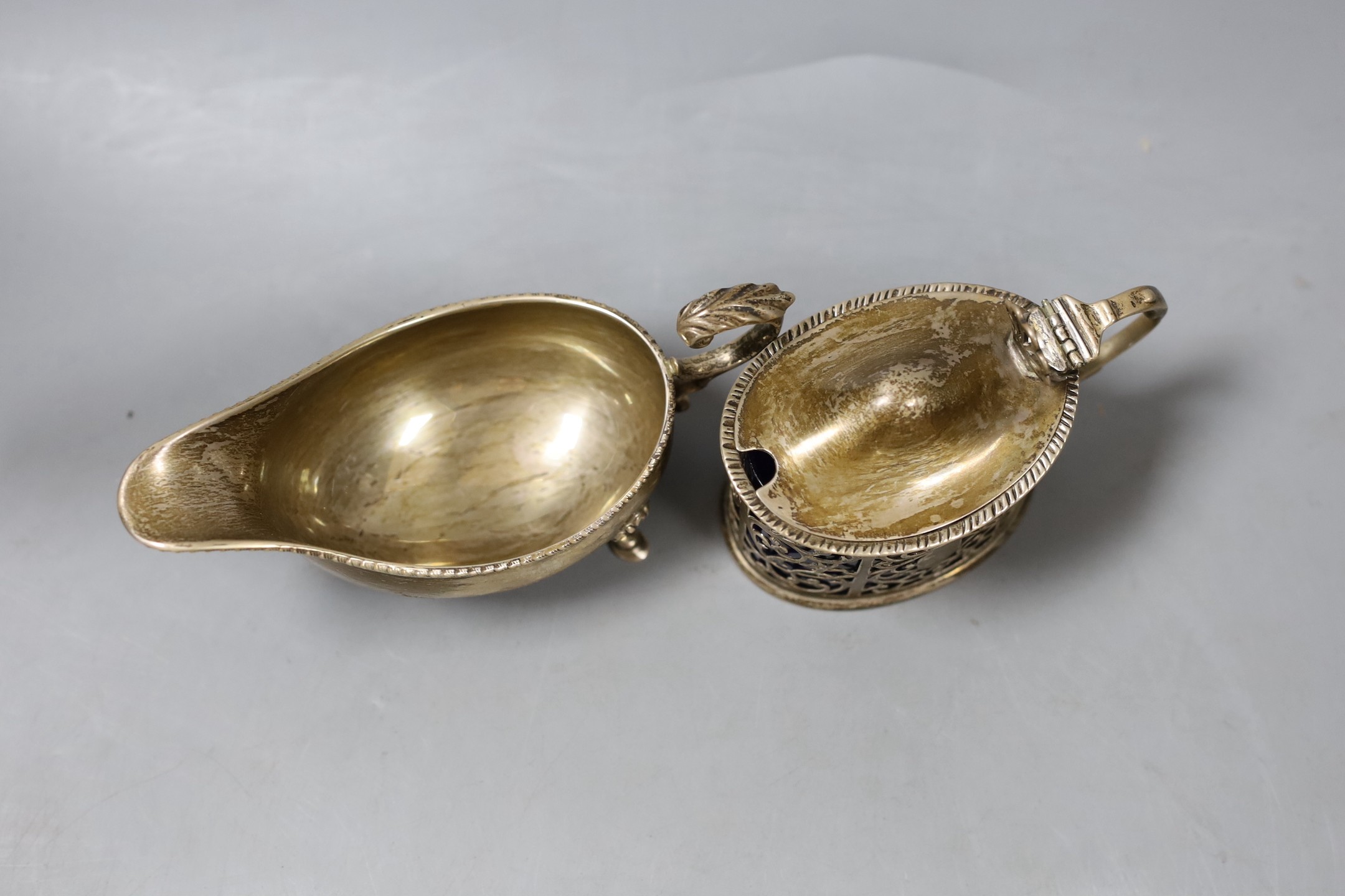A late Victorian silver mustard, London, 1899 and a later silver sauceboat.
